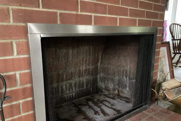 Water staining inside a brick fireplace after rain