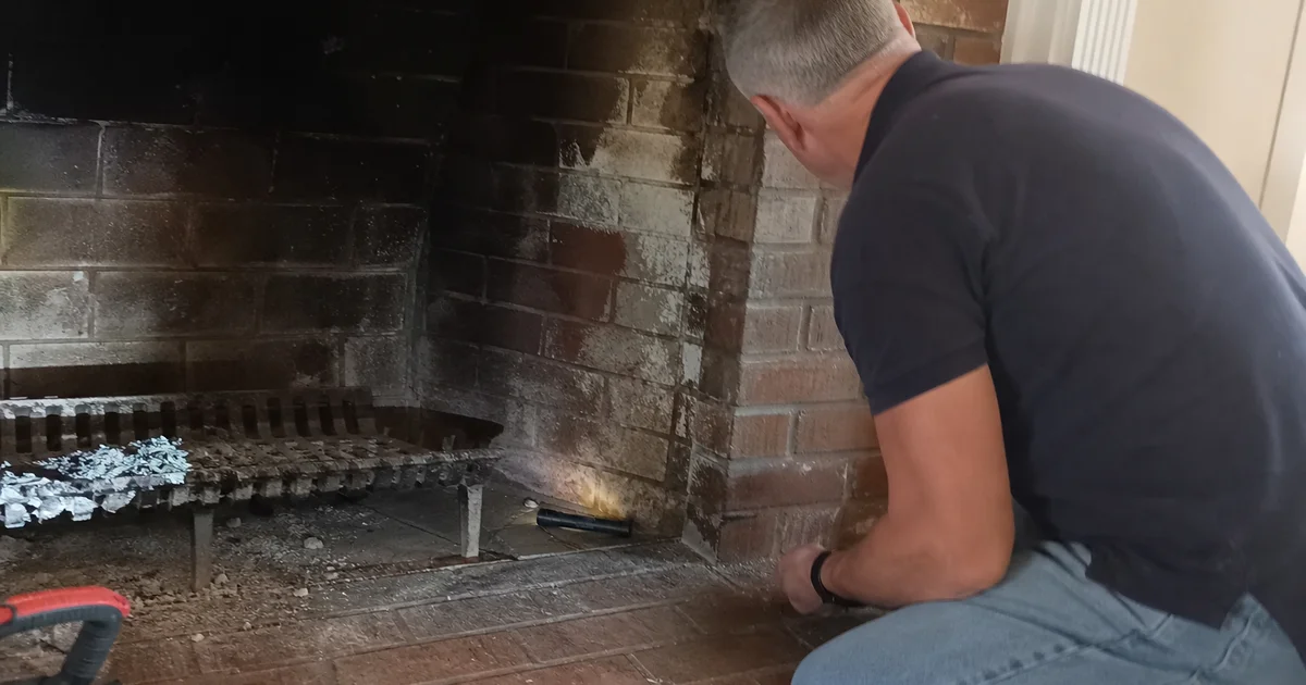 Water stains and dampness inside a brick fireplace after rain