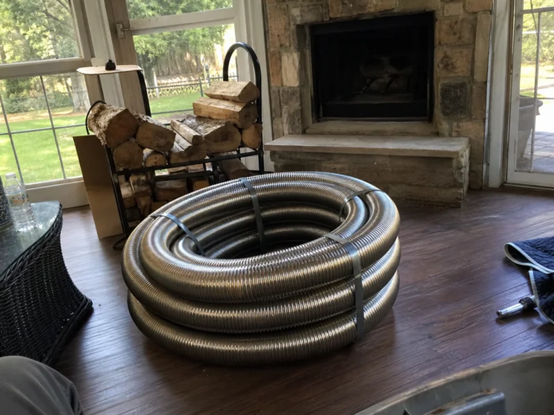 Coil of stainless steel chimney liner ready for installation
