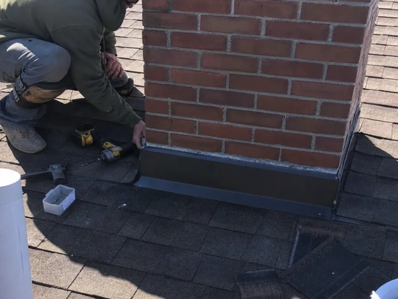 Fresh step and counter flashing sealed at a chimney base