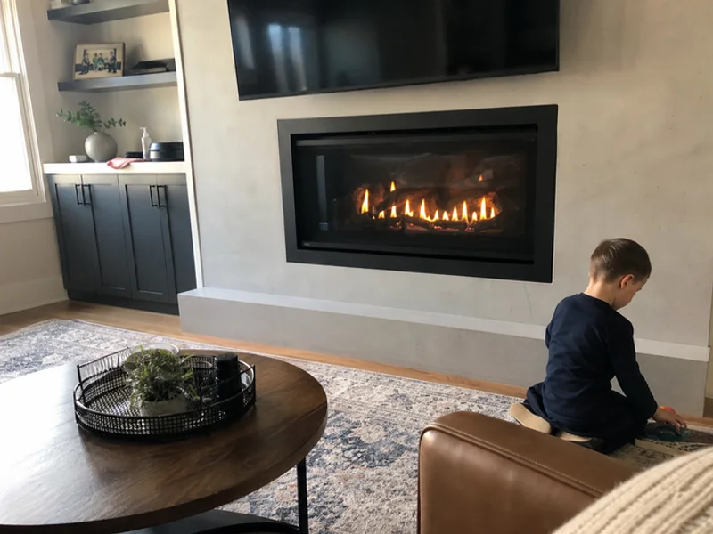 Modern gas fireplace with glass front and ambient flames