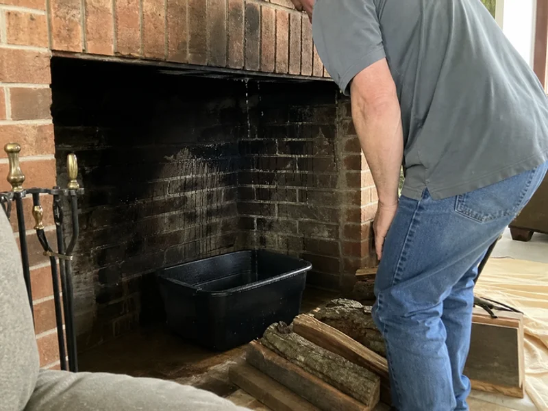 Water leaking into a brick fireplace during a rainstorm