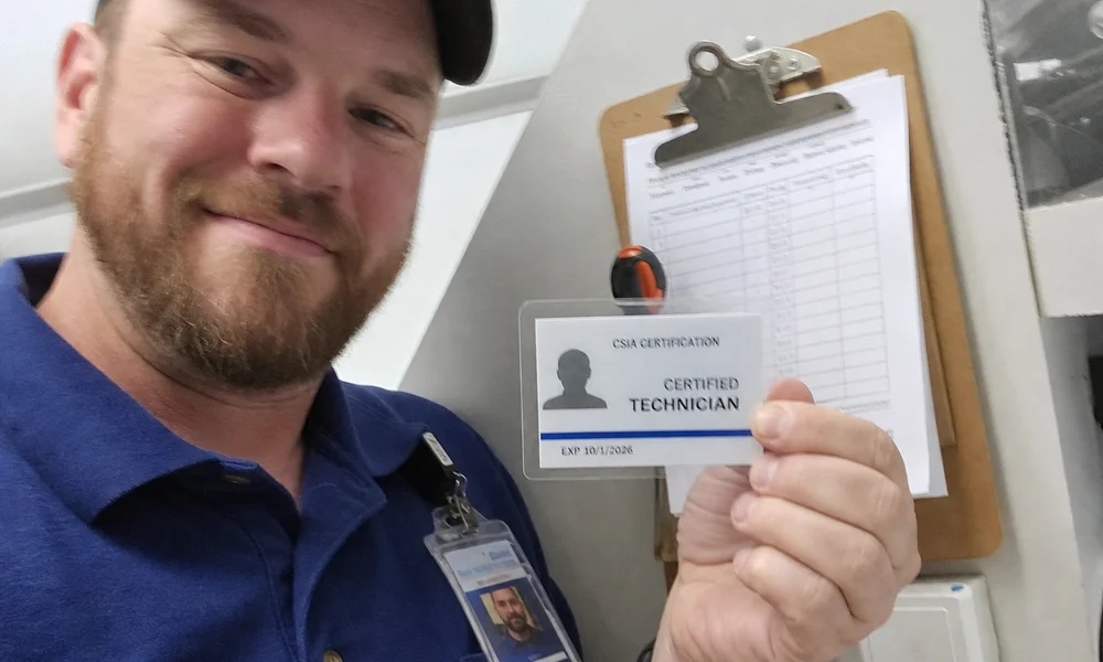 Close-up of a CSIA certification card and company ID badge