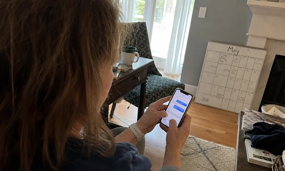 Homeowner scheduling a chimney sweep by text before the heating season