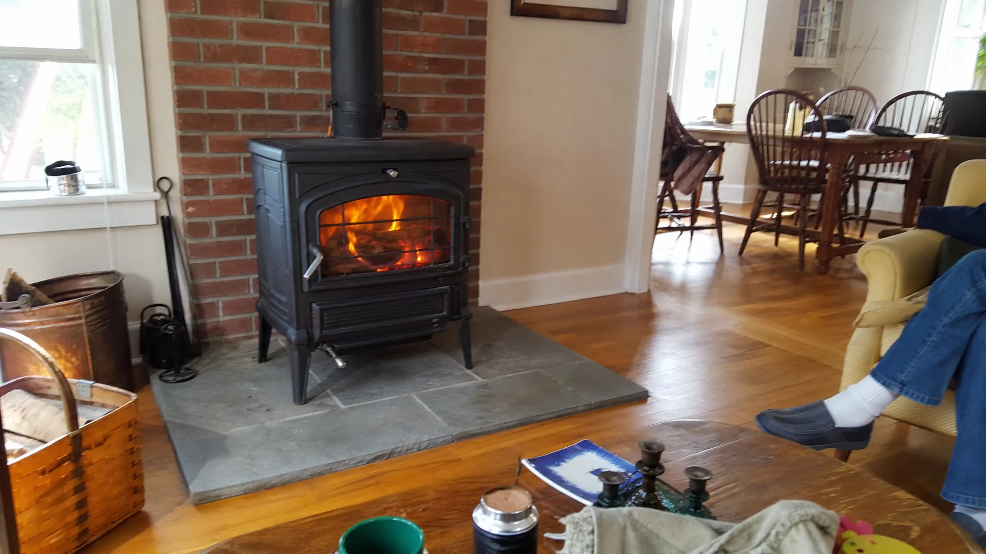 Newly installed wood-burning stove on a hearth pad in a New England living room