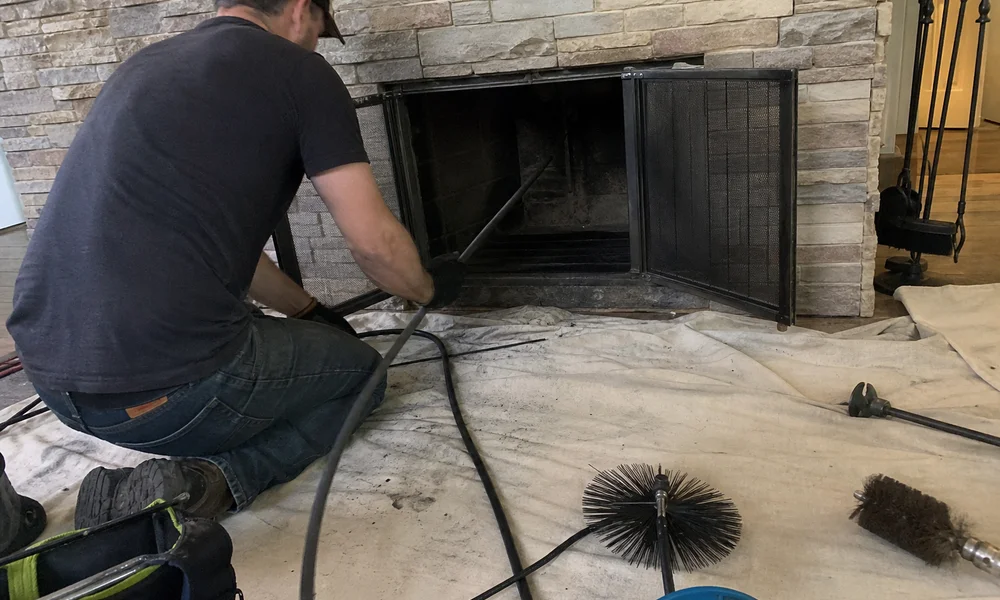 Professional rotary chimney cleaning equipment laid out on a drop cloth