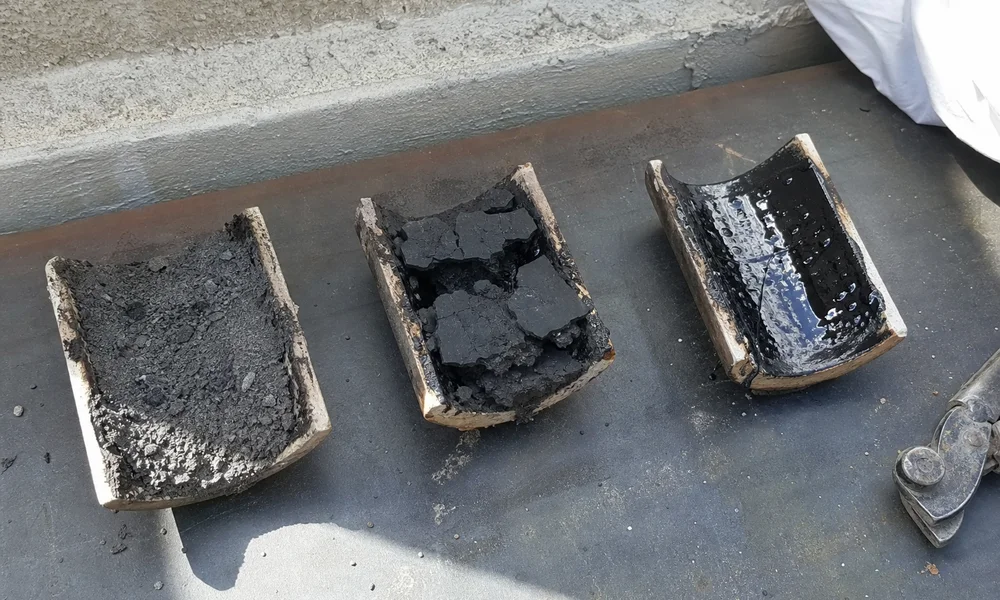 Three creosote samples — powdery, flaky, and glazed tar — side by side