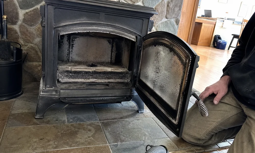 Wood stove flue showing creosote buildup at the 1/8 inch threshold